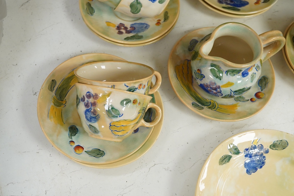 A collection of Doulton Brangwynware to include cups and saucers and a milk jug, largest 19cm in diameter